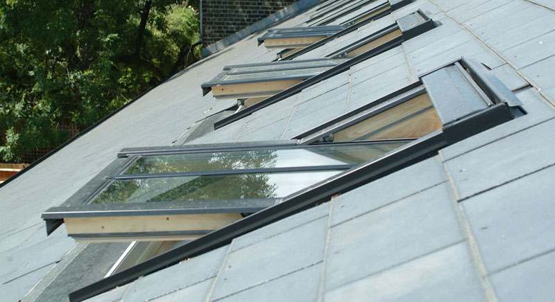 Click here to view this image of Traditional Look & Style in full screen with accompanying information. Short version: Velux Conservation Roof Windows with black external profiles for traditional buildings available in centre pivot or top hung with recessed installation for slate and tiled roofs. Photograph of Traditional Look & Style